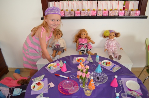 Their friend Sophia giving her doll her birthday lunch.