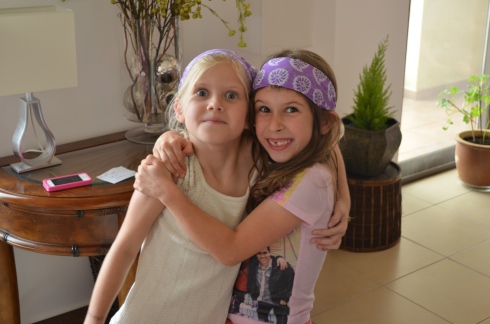 Caroline and Grace (one of the twins who went to Africa with us - Carly is her twin sister.)  All the girls at the party got those purple headbands (and mini ones for their dolls to match).  My tailor in our building downstairs made those for them :)